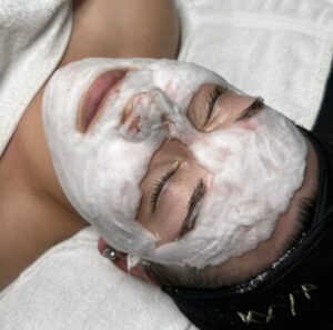 A person with facial mask on laying down