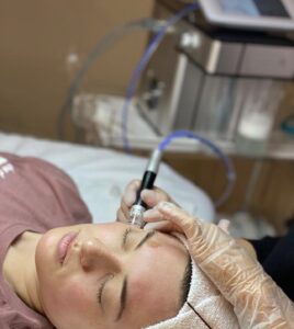 A woman laying in bed with an electric device.