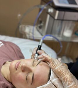 A woman laying in bed with an electric device.